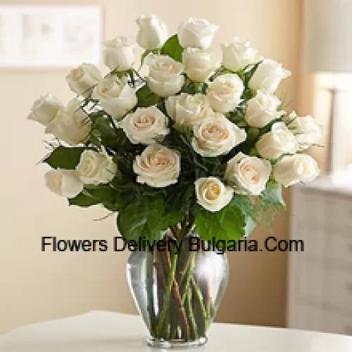 25 White Roses With Some Ferns In A Glass Vase